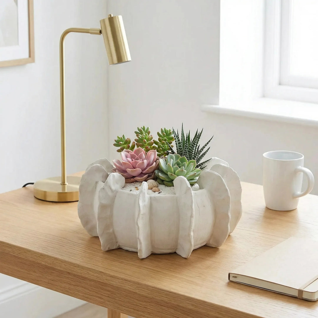 Vaso in ceramica artigianale con succulente su scrivania minimal con lampada e taccuino
