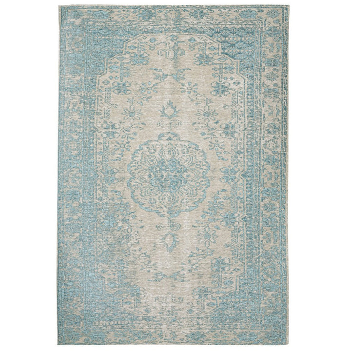 Tappeto persiano rettangolare con motivo centrale floreale e bordatura azzurro polvere, su fondo beige chiaro.

